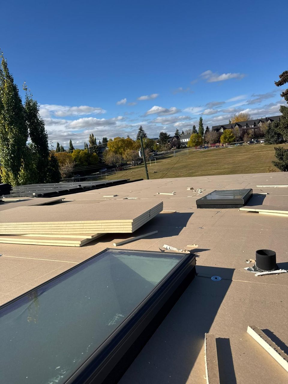 Insulation boards and a new skylight during a flat roof replacement
