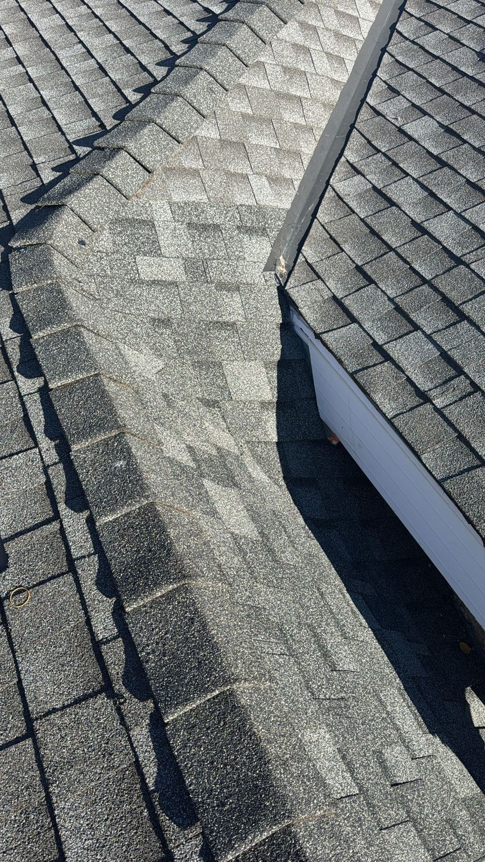 New asphalt shingles and hip cap shingles on a repaired Calgary roof