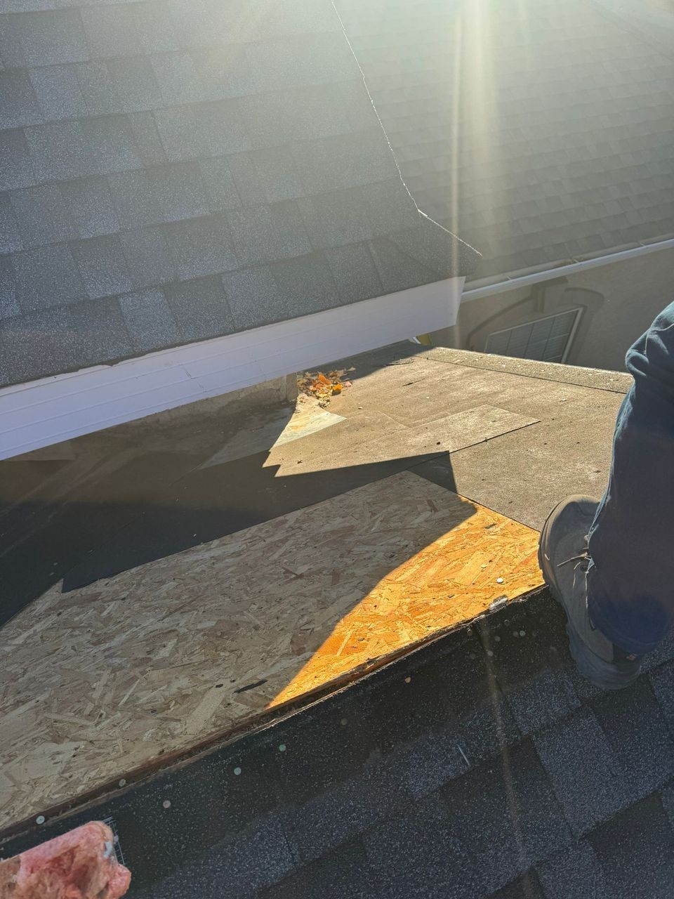 New OSB roof sheathing on a low-slope section during a shingle roof repair