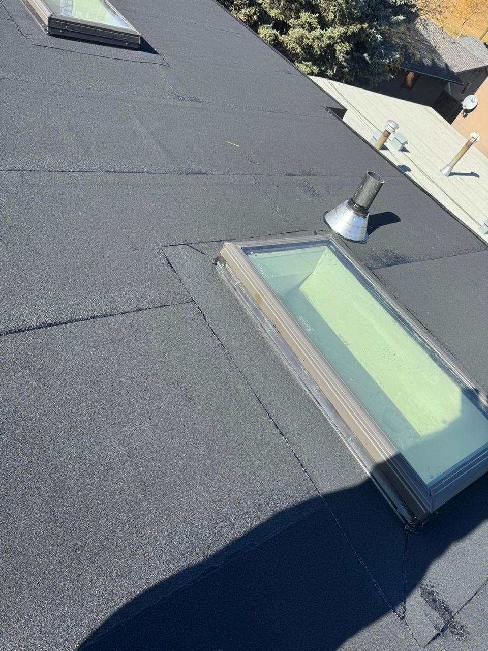New skylight flashed into the SBS cap sheet on a low-slope roof