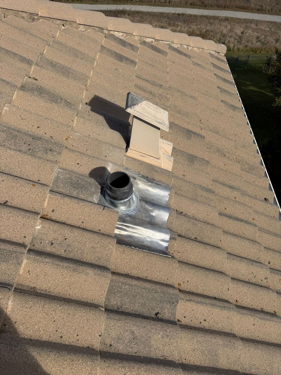 New plumbing vent flashing replaced on a concrete tile roof in Calgary