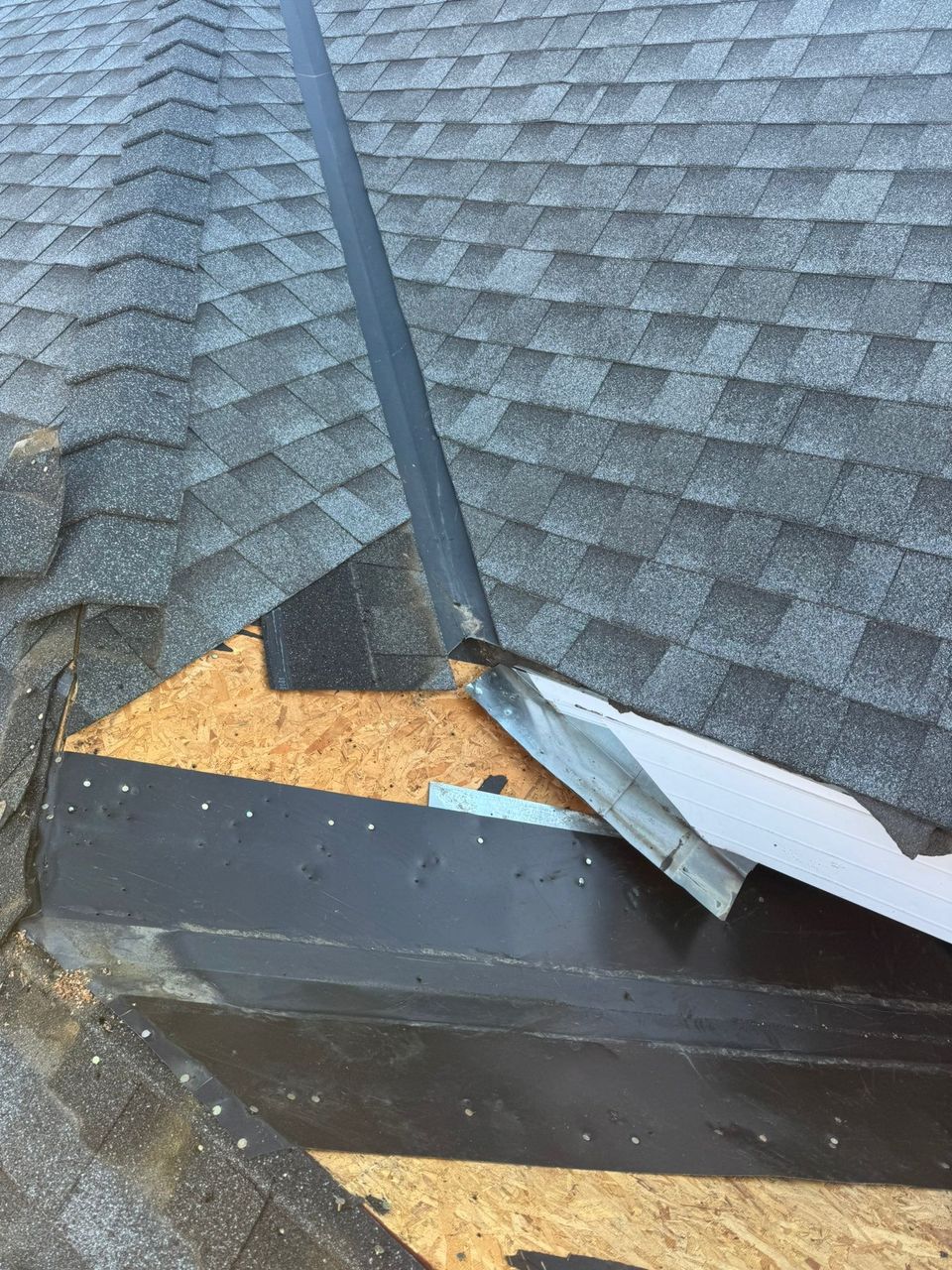 Roof valley tie-in rebuilt with self-adhered membrane and new metal flashing