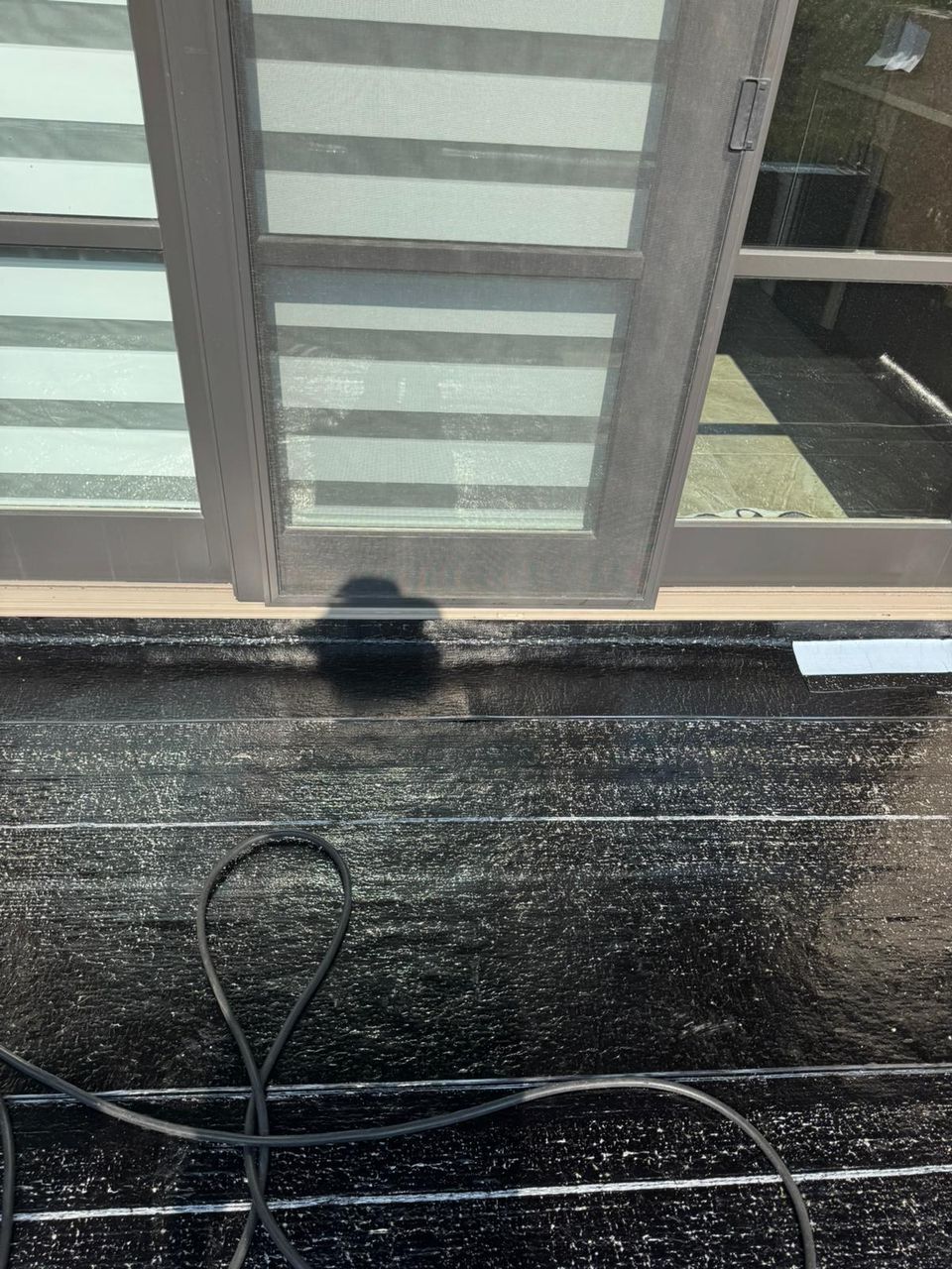 SBS base sheet installed at a balcony sliding door threshold