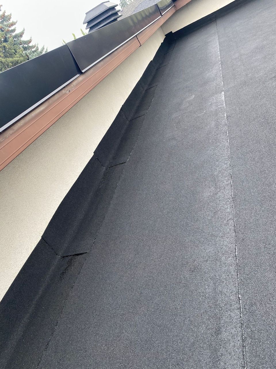 SBS cap sheet turned up a wall under metal counter flashing